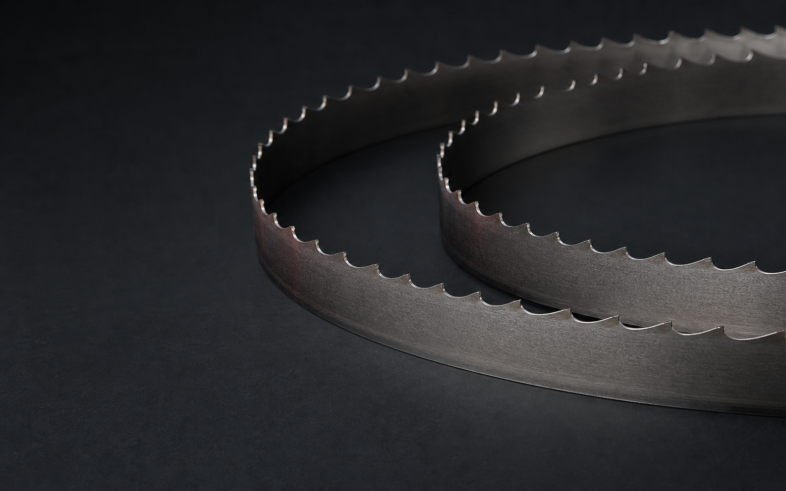 Coiled bandsaw blade with close-up tooth detail